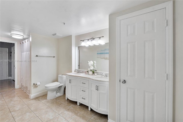 bathroom featuring tile patterned floors, vanity, and toilet