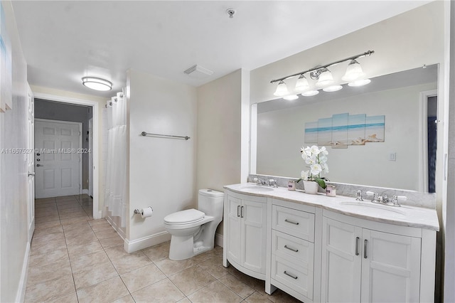 bathroom with tile patterned floors, vanity, and toilet