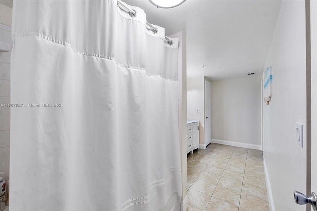 bathroom with tile patterned flooring, vanity, and a shower with curtain