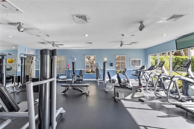 workout area featuring a textured ceiling and ceiling fan