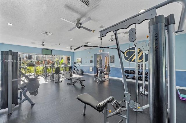 gym with a textured ceiling and ceiling fan