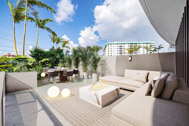 view of patio featuring outdoor dining space and an outdoor living space with a fire pit