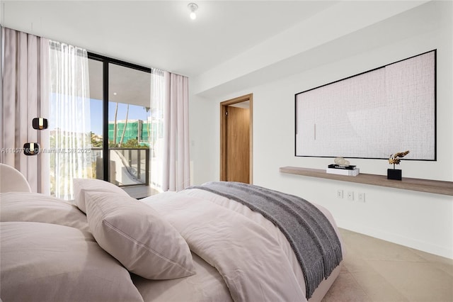 bedroom featuring a wall of windows, access to outside, and baseboards