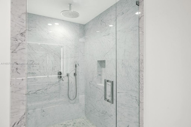 full bath with a marble finish shower