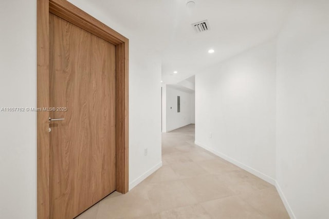 corridor featuring recessed lighting, visible vents, and baseboards