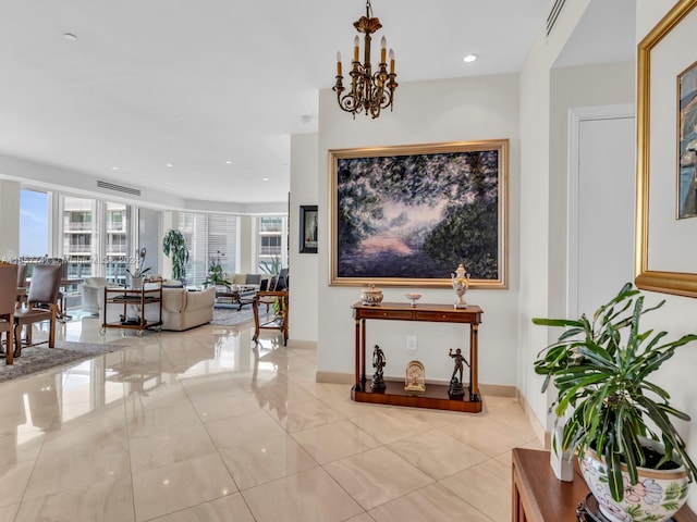 hallway with an inviting chandelier and light tile patterned floors