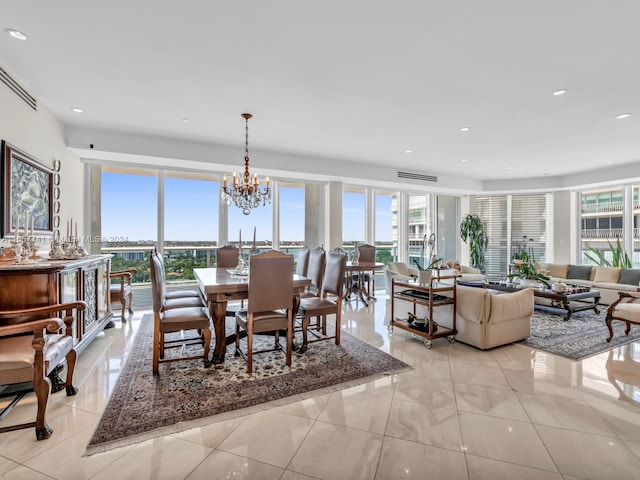 tiled dining space with an inviting chandelier and plenty of natural light