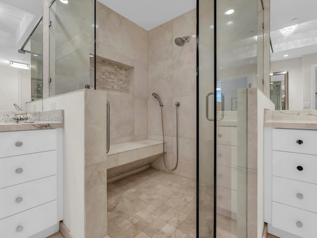 bathroom featuring walk in shower and vanity