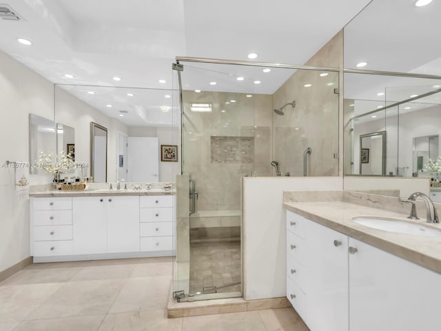 bathroom with tile patterned flooring, vanity, and an enclosed shower