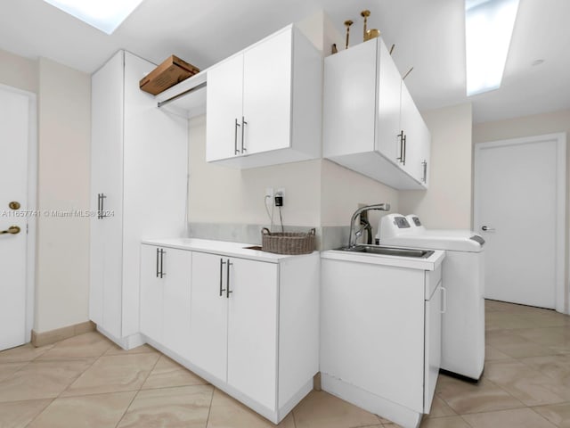 washroom featuring cabinets, light tile patterned floors, and sink