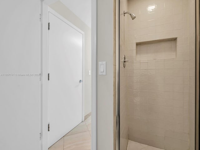 bathroom featuring tile patterned flooring and a shower with door