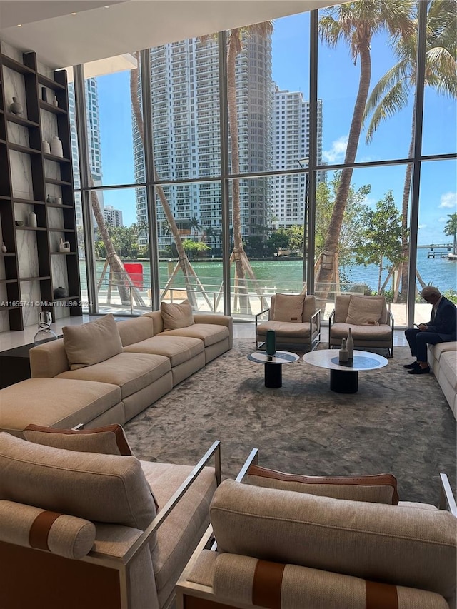 living room with floor to ceiling windows, plenty of natural light, and a water view