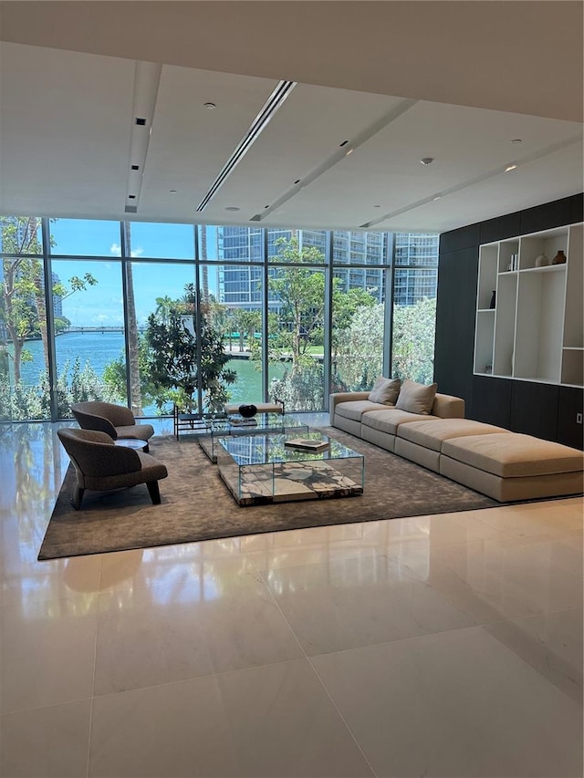 unfurnished living room with floor to ceiling windows, tile patterned flooring, and a healthy amount of sunlight