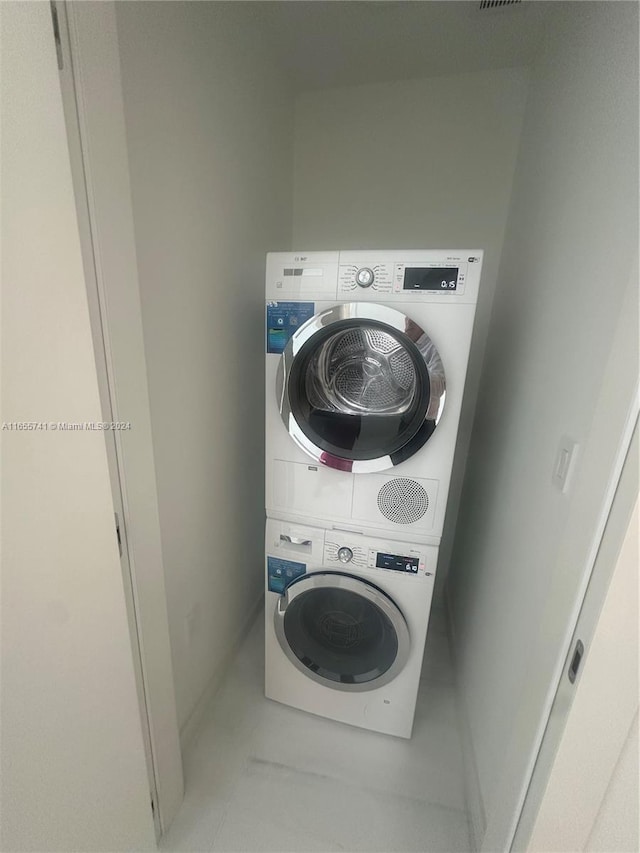 clothes washing area with stacked washer / drying machine