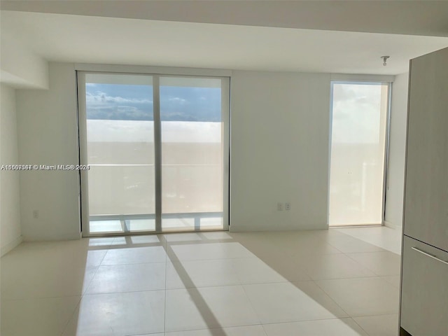 spare room with light tile patterned floors