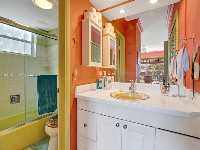 bathroom featuring vanity, a ceiling fan, recessed lighting, toilet, and combined bath / shower with glass door