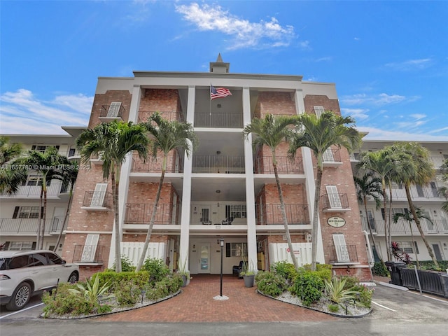 view of building exterior with uncovered parking