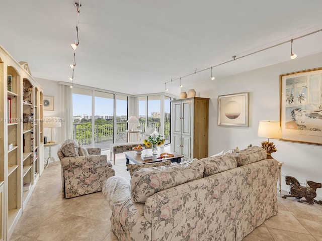 tiled living room featuring floor to ceiling windows and track lighting