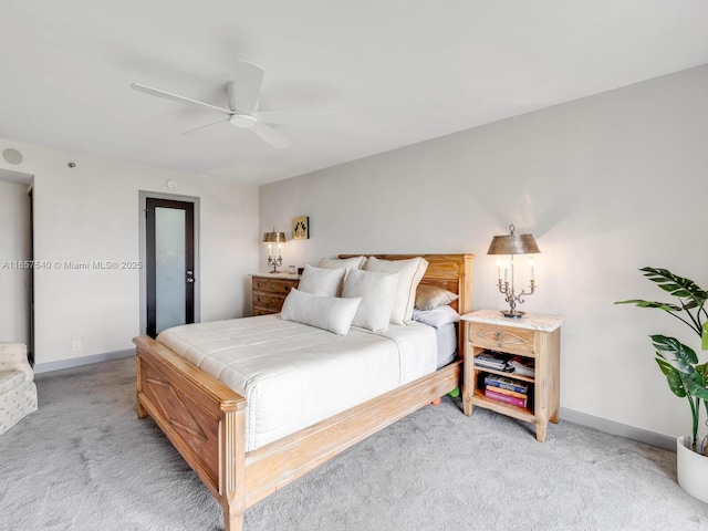 bedroom with ceiling fan and light carpet