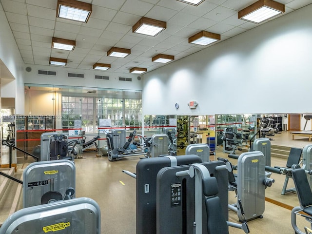 gym with a paneled ceiling