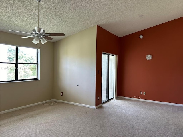 unfurnished bedroom featuring light carpet, a textured ceiling, and ceiling fan