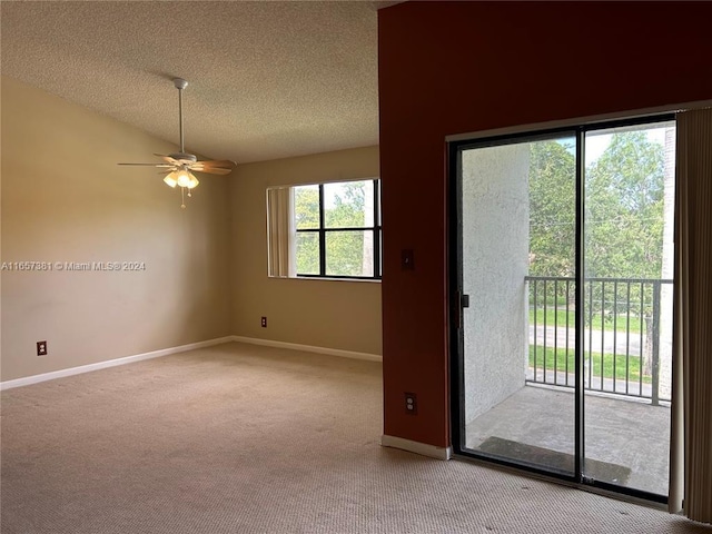 entryway with a textured ceiling, light colored carpet, and ceiling fan