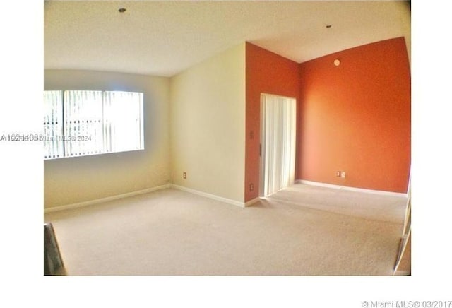 carpeted spare room featuring a textured ceiling