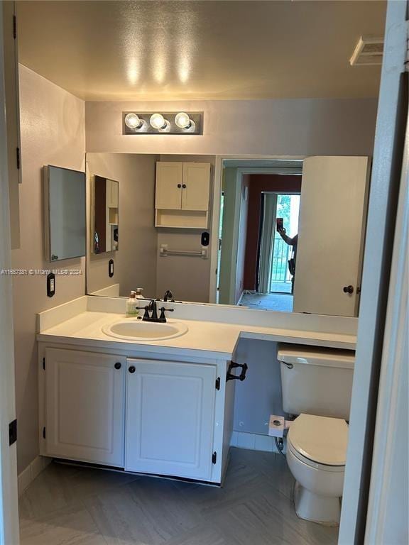 bathroom featuring vanity and toilet