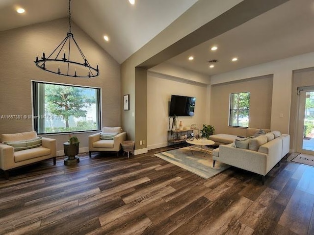 living room featuring high vaulted ceiling, dark hardwood / wood-style flooring, and a notable chandelier