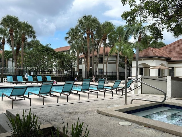 view of pool with a community hot tub and a patio area