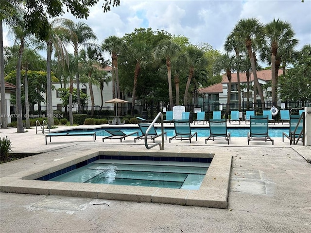 view of pool with a hot tub