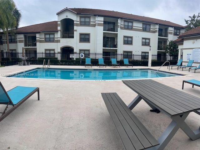 view of swimming pool with a patio area