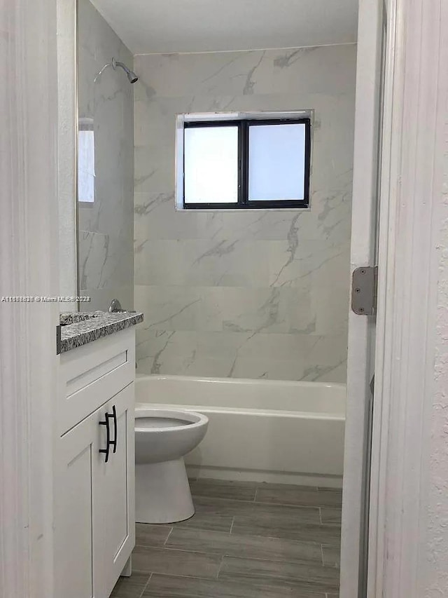 1810 NW 69th Ter, Miami, FL 33147 - bathroom featuring toilet, vanity,  shower combination, and wood finish floors