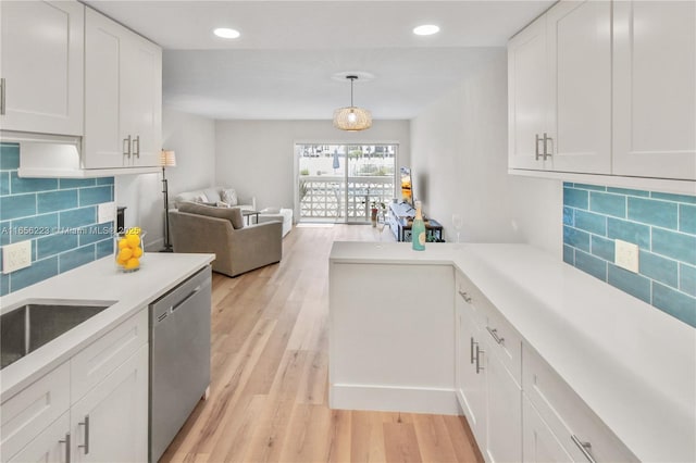 kitchen featuring dishwasher, hanging light fixtures, decorative backsplash, light wood-type flooring, and white cabinetry