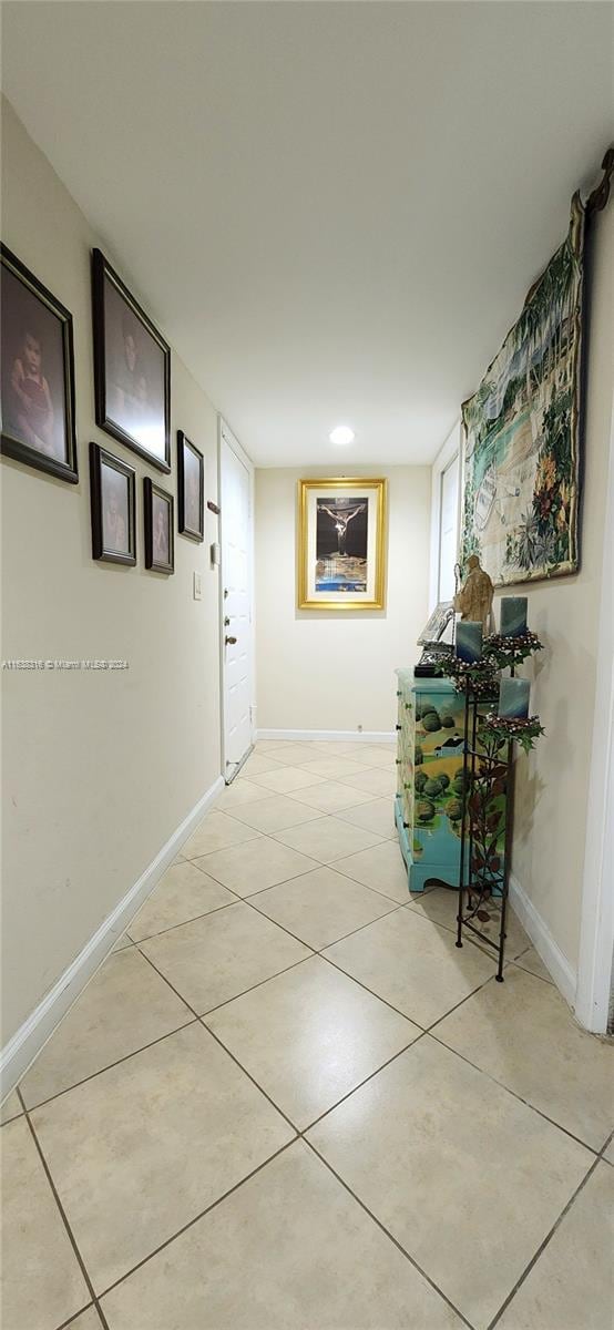 corridor featuring light tile patterned floors