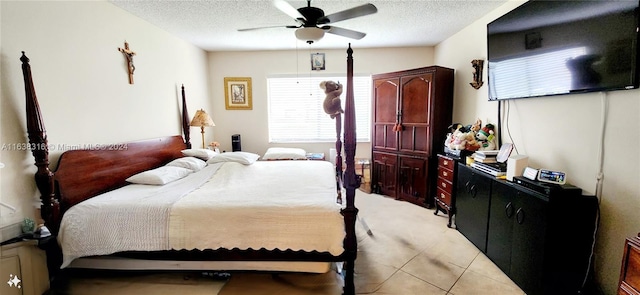 tiled bedroom featuring a textured ceiling and ceiling fan