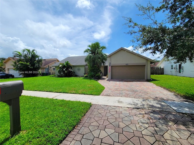 ranch-style house featuring a front lawn and a garage