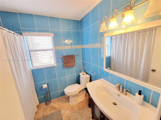 full bathroom with tile patterned floors, toilet, tile walls, and vanity