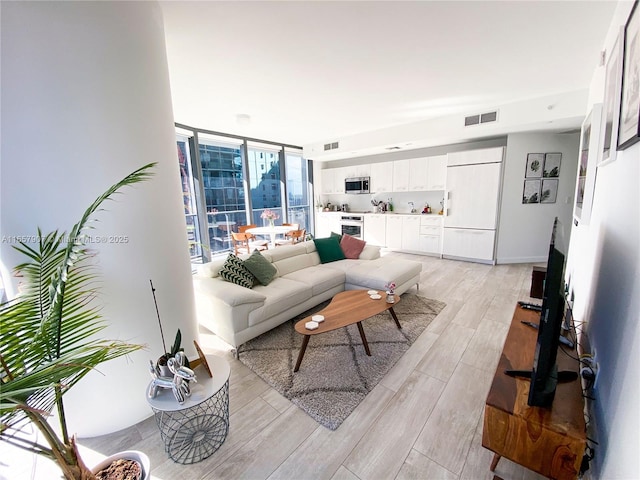 living room featuring floor to ceiling windows