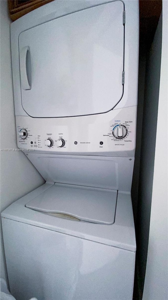 laundry area featuring stacked washing maching and dryer