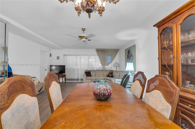 dining area with ceiling fan, dark hardwood / wood-style flooring, and a textured ceiling