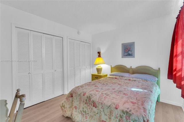215 SE 3rd Ave Unit 407B, Hallandale Beach, FL 33009 - bedroom with baseboards, multiple closets, and wood finished floors