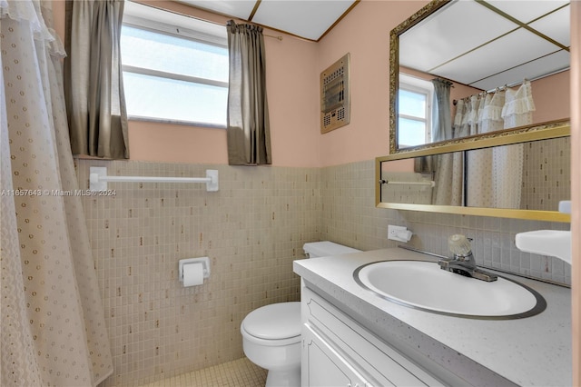 bathroom featuring a shower with shower curtain, tile patterned floors, toilet, tile walls, and vanity