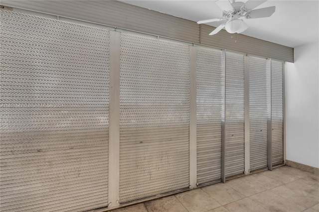 interior space featuring ceiling fan and tile patterned flooring