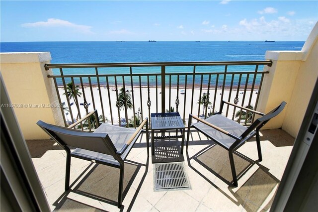 view of pool with a water view, a beach view, and a patio