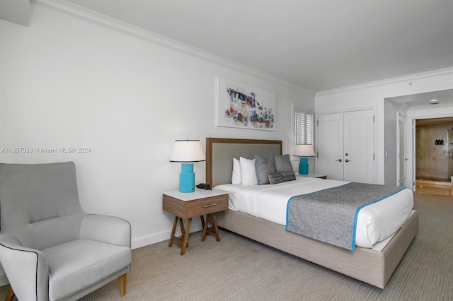 bedroom featuring carpet, ornamental molding, and a closet