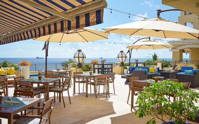 view of patio / terrace with outdoor lounge area and a water view