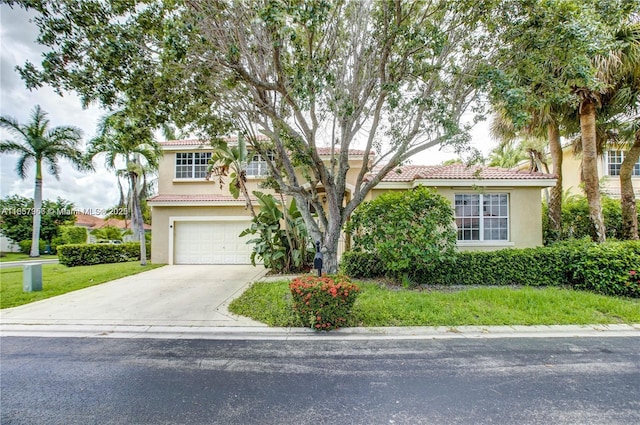 mediterranean / spanish-style house with a front lawn and a garage