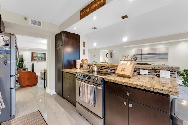 kitchen featuring dark brown cabinets, hanging light fixtures, stainless steel appliances, light stone countertops, and decorative backsplash