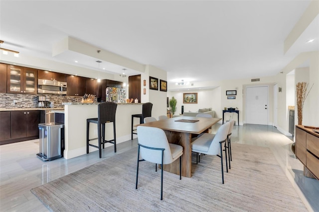 dining area featuring light wood-type flooring